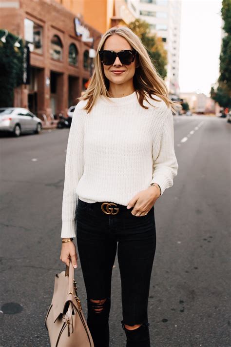 Blonde Woman Wearing Ivory Knit Sweater Black Ripped Jeans Gucci Logo