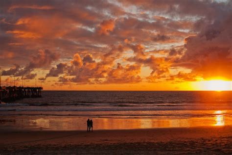 Premium Photo A Couple Stands On The Beach At Beautiful Sunset Near The Pacific Ocean California