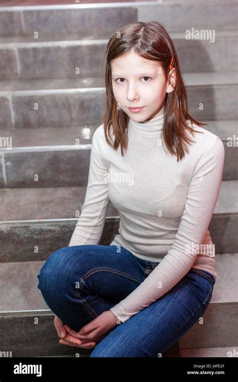 Teen Girl Sitting On Stairs Indoor Portrait Of A Sad Teenage Girl