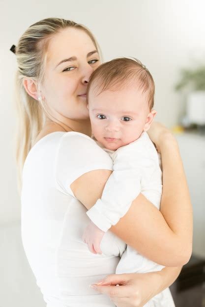 Premium Photo Beautiful Smiling Mother Cuddling Her Months Old Baby