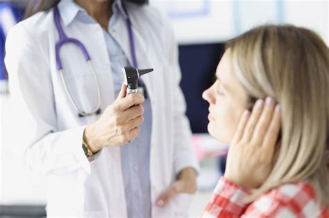 Premium Photo Otorhinolaryngologist Examines Patient Ear With An Otoscope