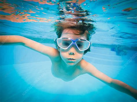 Boy Swimming Underwater In Swimming Pool Stock Image F0161712
