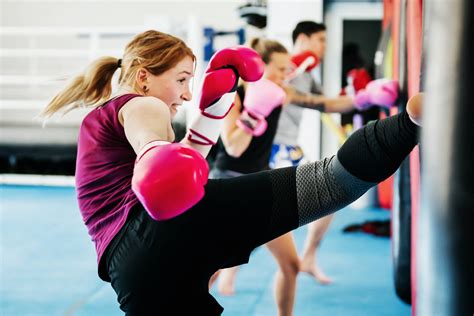 Download Girl Kickboxing Training At A Gym Wallpaper
