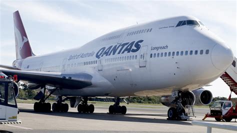 qantas flight qf26 from tokyo to sydney forced to make emergency landing in cairns after engine