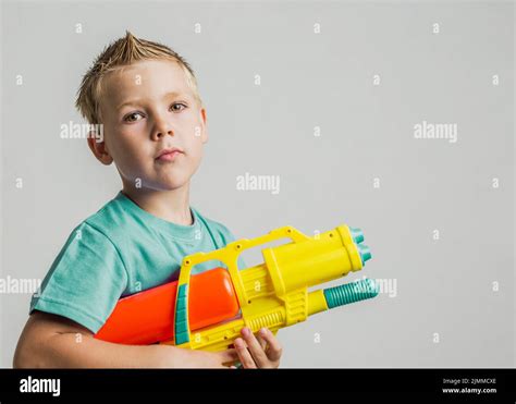 Cute Kid Playing With Water Gun Stock Photo Alamy