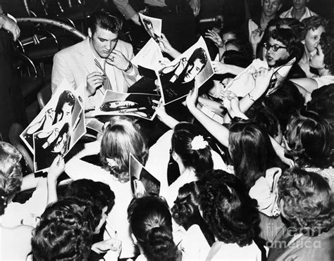 Elvis Presley Signing Autographs By Bettmann