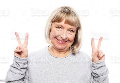 Old Woman Laugh And Showing Peace Or Victory Sign At Camera Emotion And