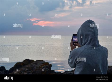Landscape Photo Of A Woman Or Person Photographing Ocean Or Sea At