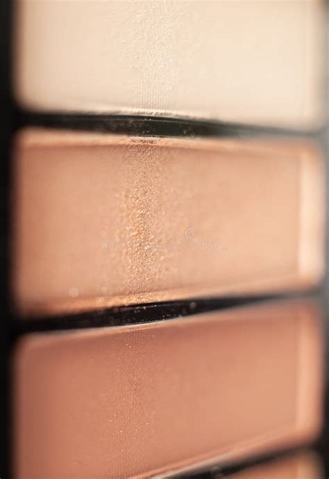 An Eyeshadow Pallet Featuring Nude Shades Drops Of Foundation Falling