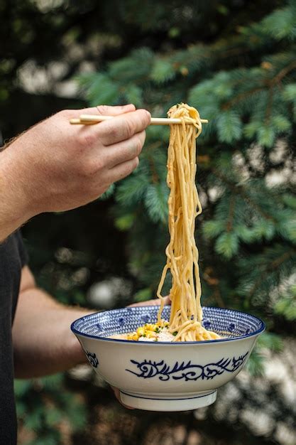 Premium Photo Eating Japanese Ramen Noodles Soup With Chopsticks