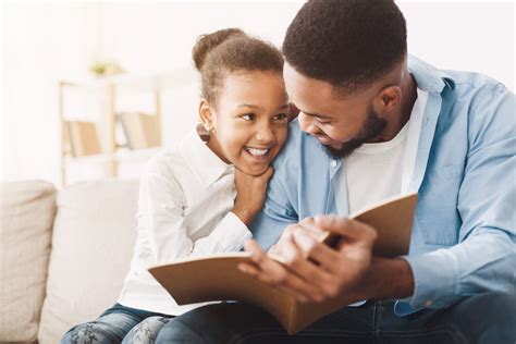 African American Dad And Daughter Spending Time Reading Book Studer