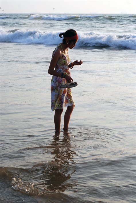 Girl On Mobile In The Surf Profile Baga Beach Goa Martha Burzynski