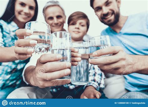 You can continue downloading in. Smiling Family Drinking Water In Glasses At Home. Stock ...