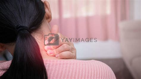 Close Up Of Female Massaging Her Painful Neck Caused By Prolonged Work