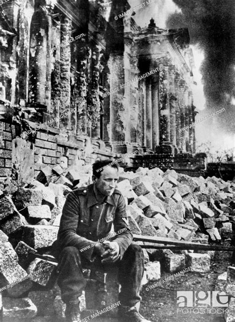 Second World War German Soldier Sits Amongst The Ruins Of The