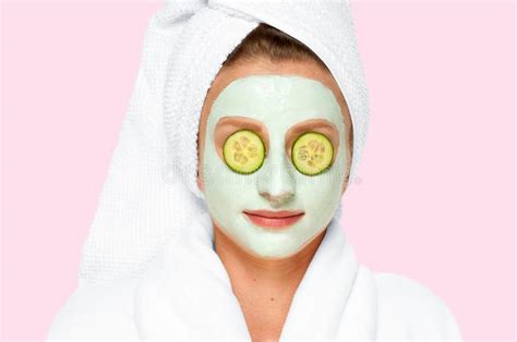 Beauty Spa Woman With Facial Clay Mask And Cucumbers On Eyes Stock