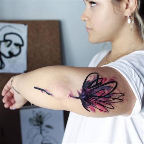 Abstract Lotus Flower Tattoo On The Back Of Her Left