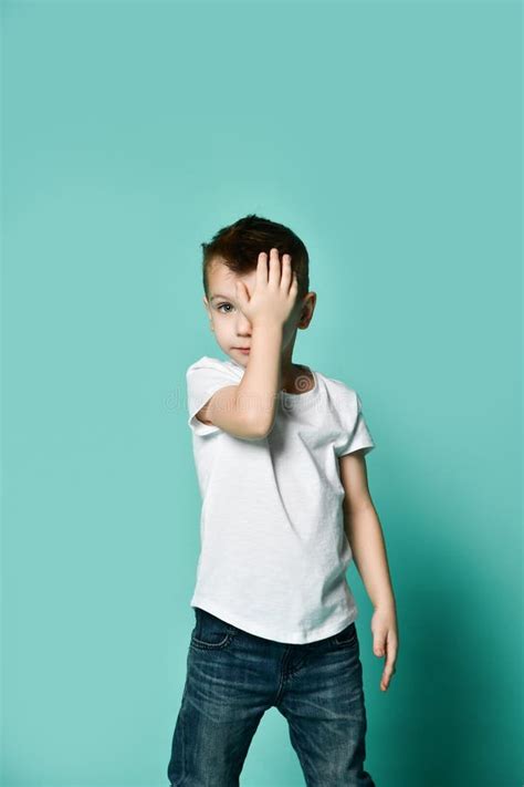 Portrait Of Unhappy Sad Bored Kid Boy Leaning Head On Palm Looking With