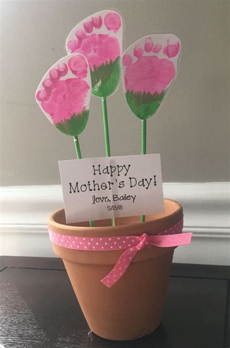 Some Pink Flowers In A Pot With A Happy Mothers Day Sign On It