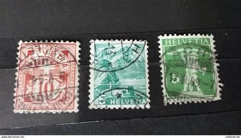 Three Different Stamps On A Black Surface One Is Green And The Other