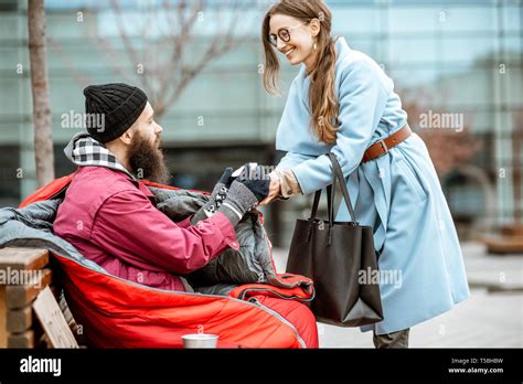 Smiling Woman Helping Homeless Beggar Giving Some Hot Drink Outdoors