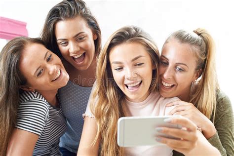 Group Of Teenage Girls Taking Selfie On Mobile Phone Stock Image