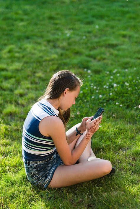 Teenage Girl Using Electronic Device While Outdoors By Stocksy Contributor Ronnie Comeau