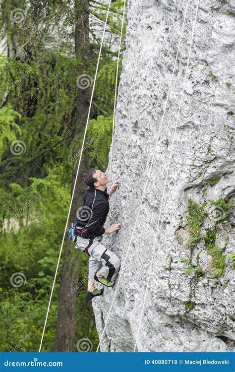 Man Climbing Steep And High Rocky Wall Stock Photo Image Of Extreme