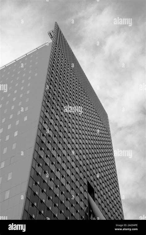 Vertical Grayscale Low Angle Shot Of A High Rise Building Under The
