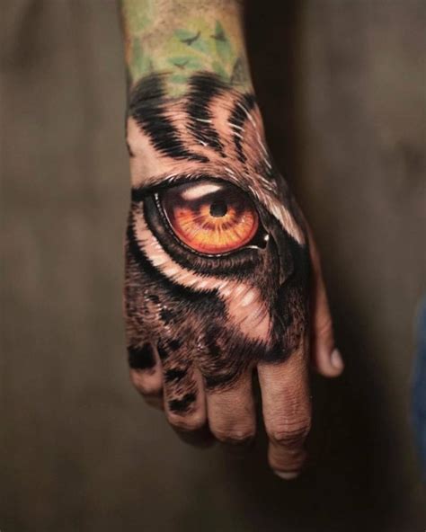 Realistic Tiger Eye Tattoo Located On The Hand