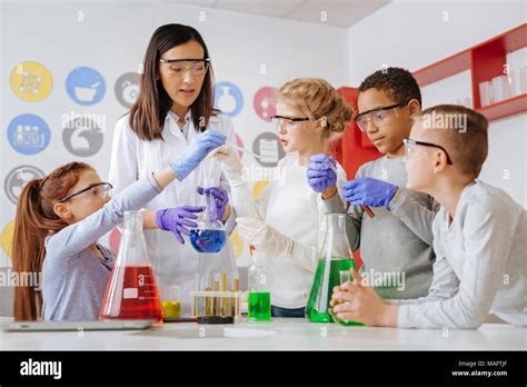 Group Of Students And Their Teacher Conducting Chemical Experiment