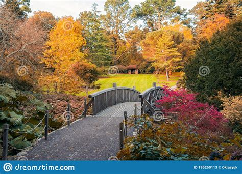 Beautifull Scenic Arched Wooden Bridge With Fall Leaves In Autumn