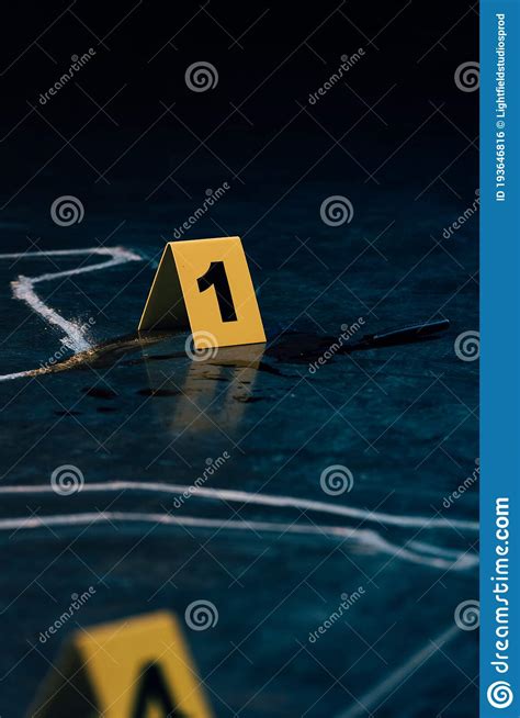 Selective Focus Of Chalk Outline And Evidence Markers Stock Photo