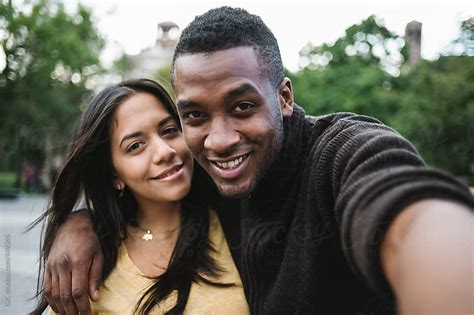 Black Young Couple Taking A Selfie In The City By Gic Couple Technology Stocksy United