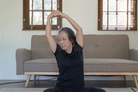 Portrait Of Mature Woman Doing Stretching Yoga Side Bend Exercise And