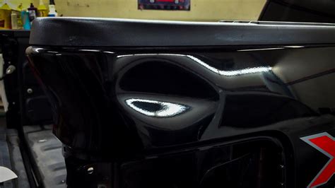 The rear corner sunshade on the driver side had cracked and lost all tension, leaving the shade flopping loose. 2012 Ford F-150 Rear Quarter Panel Dent | Dentique Paintless Dent Repair