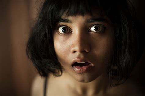 Eyes And Mouth Widely Open Of Surprised Teenage Asian Girl Stock Photo