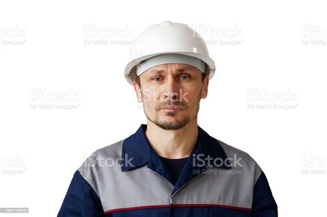 Portrait Of A Man In A White Construction Helmet And Work Clothes