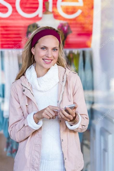 Woman Using Smartphone At Shopping Mall