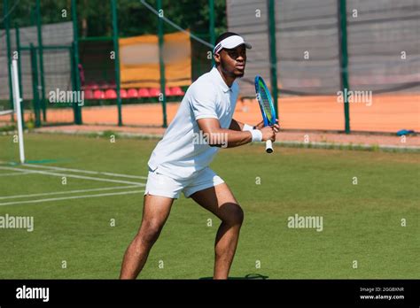 Athletic African American Man Playing Tennis On Court Stock Photo Alamy