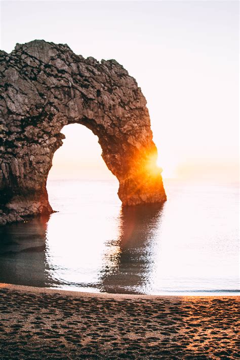 Free Images Sea Coast Rock Ocean Sunrise Sunset Sunlight