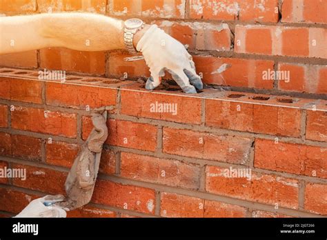 Bricklayers Laying Bricks On Mortar Stock Photo Alamy
