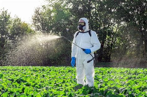 Premium Photo Farmer Spraying Pesticide Field Mask Harvest Protective