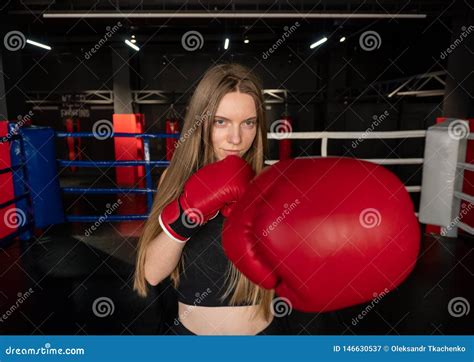 Blonde Caucasian Fighter Girl In Red Boxing Gloves Is Posing On Fight