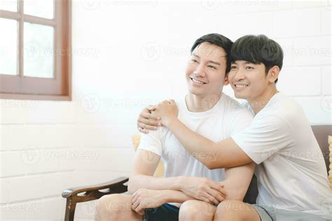 Happy Asian Gay Couple Hug Together On Sofa Asian Lgbt Couple Embracing Together At Home