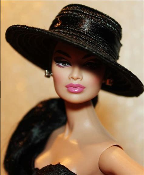 A Barbie Doll Wearing A Black Dress And Hat