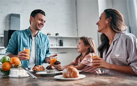 Premium Photo Mom Dad And Their Little Beautiful Daughter Have Breakfast In The Kitchen And