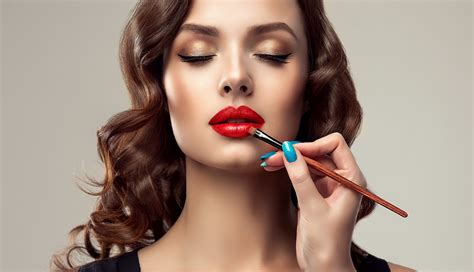 Makeup Artist Applies Red Lipstick Beautiful Woman Face Hand Of Make Up Master Painting Lips