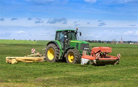 Tractor Mowing Grass On A Field Editorial Stock Image Image Of Animal