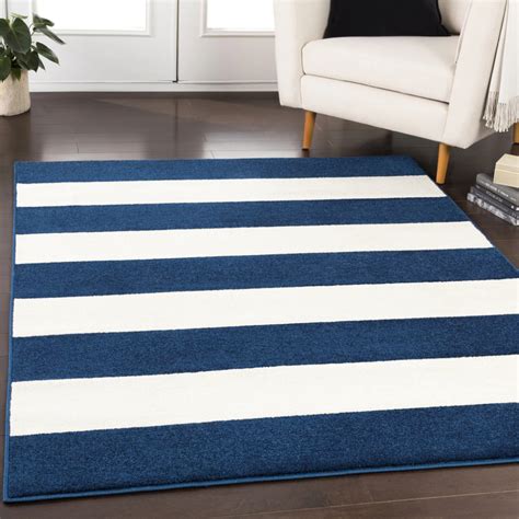 Add some black/patterned throw pillows. Horizon Navy and White Striped Plush Rug (With images ...